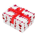 Gift box with red heart pattern and red ribbon on a white background