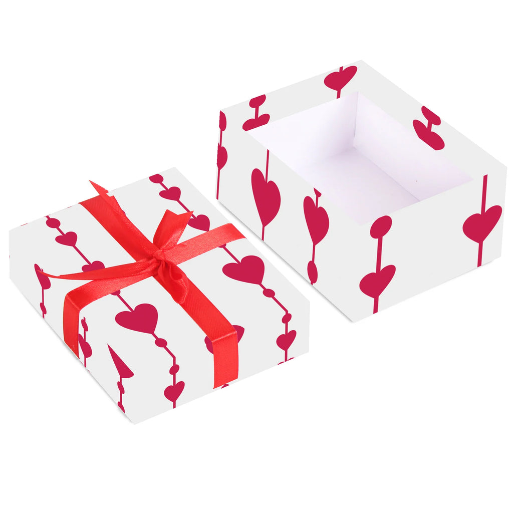 Two gift boxes with red hearts and ribbons on a white background