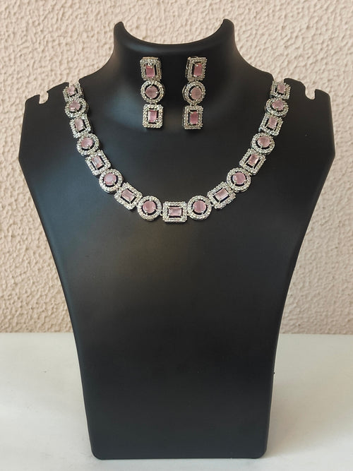 Violet Vows silver necklace set with pink geometric stones on a black display bust