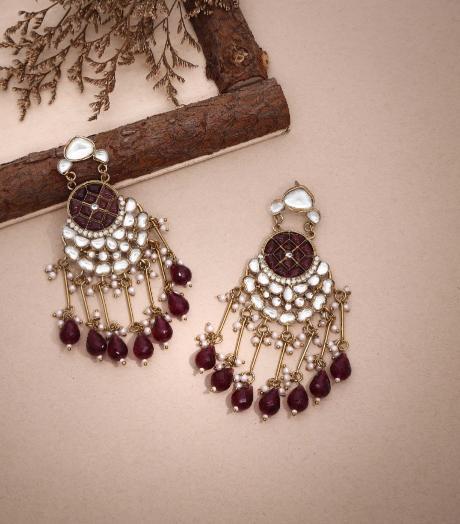 Violet Vows Bella maroon Kundan and pearl chandelier earrings in a styled product shot.
