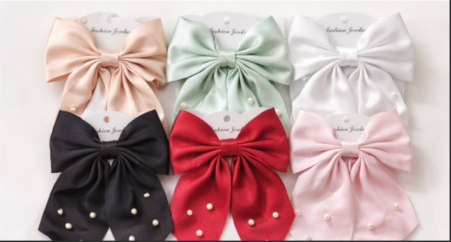 6 satin pearl bow hair clips in beige, mint, white, black, red and pink arranged in two rows