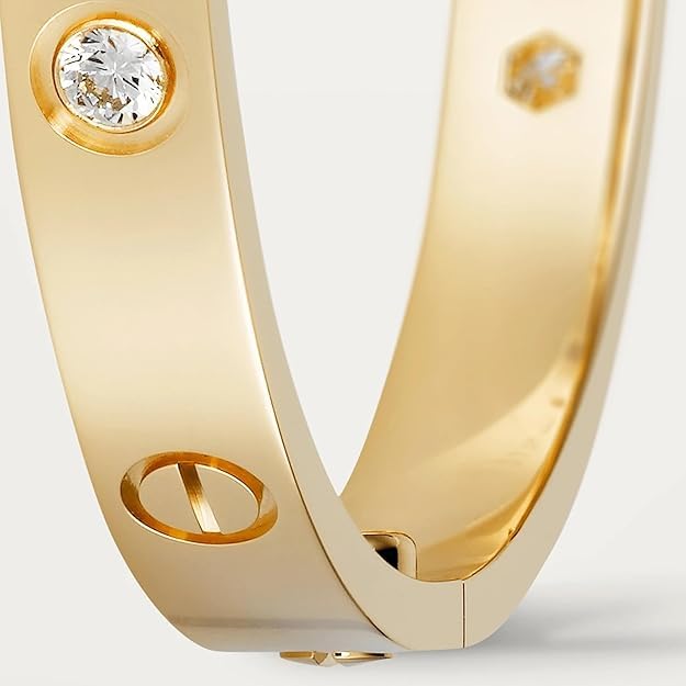 Gold ring with a diamond on a light gray background