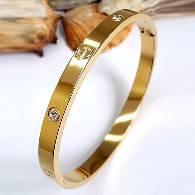 Gold bracelet with a diamond on a white background