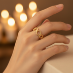 Gold open circle link band open cuff ring worn on finger with warm golden bokeh