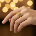 Gold belt buckle braided chain open cuff ring worn on finger with warm golden bokeh