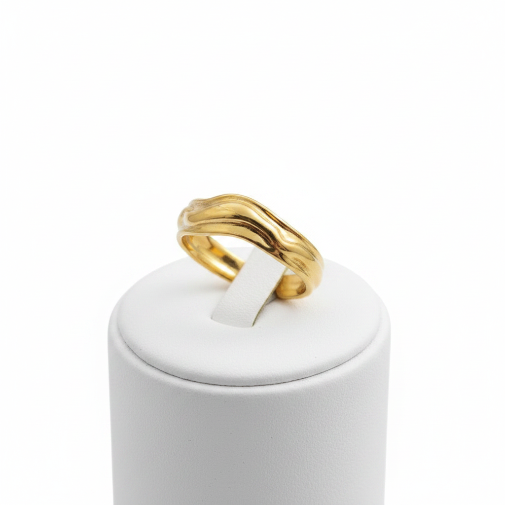 Gold molten wave sculptural open cuff ring on white jewelry stand, clean studio shot
