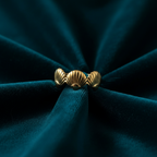 Gold triple seashell ring on ocean teal velvet fabric