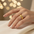 Gold twisted croissant open band ring worn on woman's finger