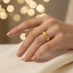 Gold twisted croissant open band ring worn on woman's finger