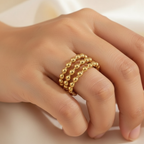 Gold Triple Row Beaded Wide Cuff Open Ring - worn on finger cream background lifestyle shot