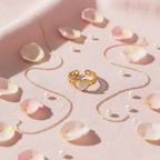 Gold chain link band white enamel heart open cuff ring on blush pink linen with rose petals and pearls