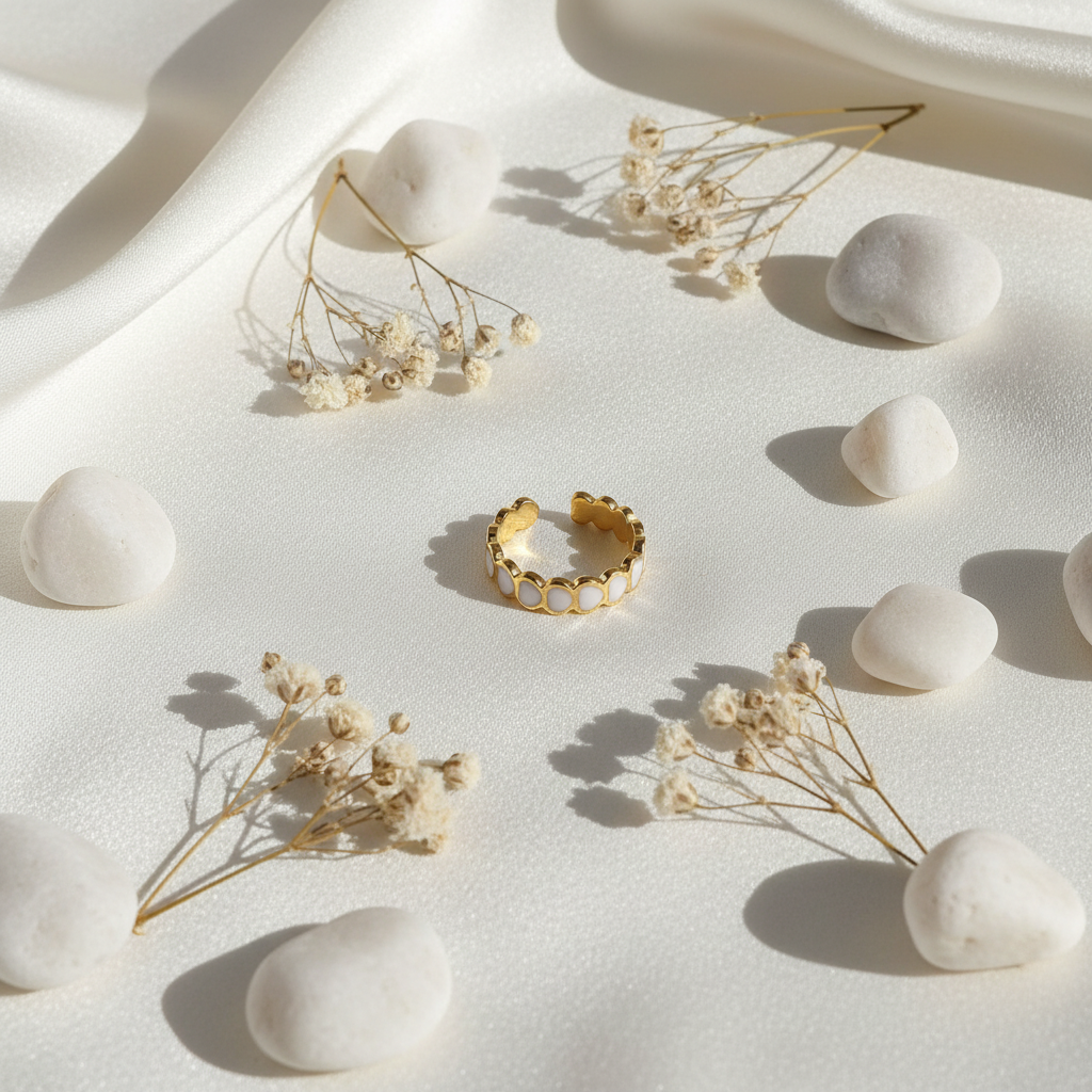 Gold white oval enamel wide band open cuff ring on ivory silk with white pebbles and dried flowers