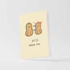 Close-up detail of peanut characters holding hands with orange bow