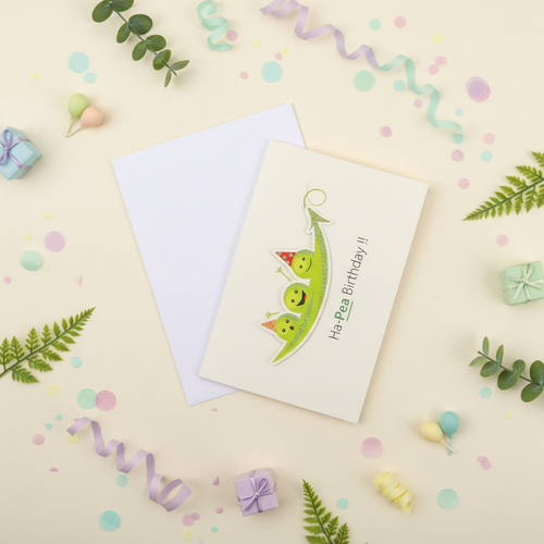Flat lay composition of birthday greeting card with envelope and celebration decorations