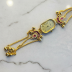Peacock Charm Bracelet Watch Ruby Edition – studio product shot
