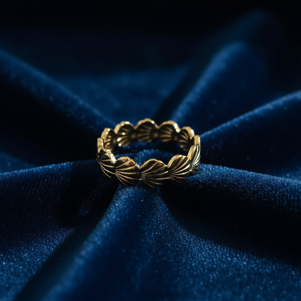 Gold seashell band ring on ocean blue velvet fabric