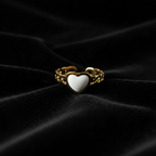 Gold chain link band white enamel heart open cuff ring on black velvet with dramatic rim lighting