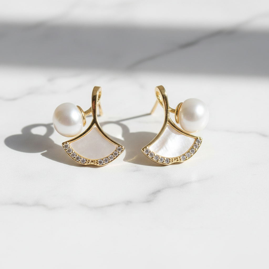 Pearl & Shell Fan Stud Earrings on white marble flat lay
