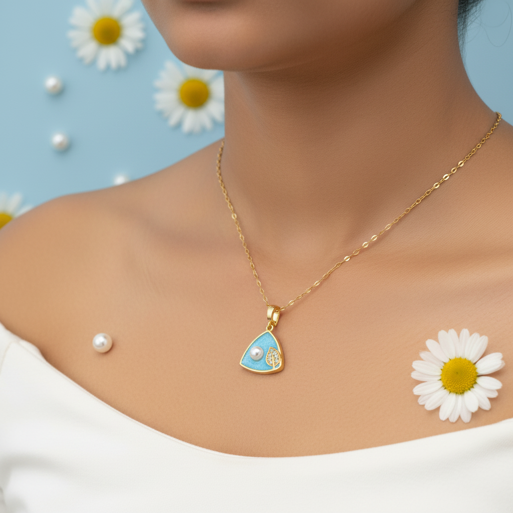 Model wearing light blue triangular enamel pendant necklace with white pearl and CZ leaf accent on gold oval link chain - jewelry by Violet Vows