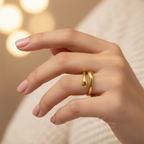 Gold hug open band ring worn on woman's finger