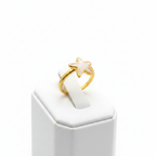 Gold white enamel starfish open cuff ring on white jewelry stand, clean studio shot