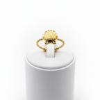 Gold seashell twisted rope open cuff ring on white jewelry stand, clean studio shot