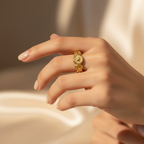 Gold coin ring worn on woman's finger