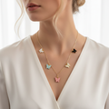 Model wearing Violet Vows gold chain necklace with multicoloured butterfly charms