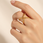Gold Hammered Double X Crossover Open Cuff Ring - worn on finger cream background lifestyle shot