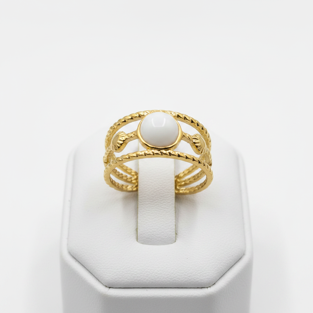Gold triple twisted rope band white oval stone open cuff ring on white jewelry stand, clean studio shot