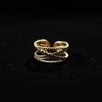 Gold double layer beaded heart open cuff ring on black velvet with dramatic rim lighting