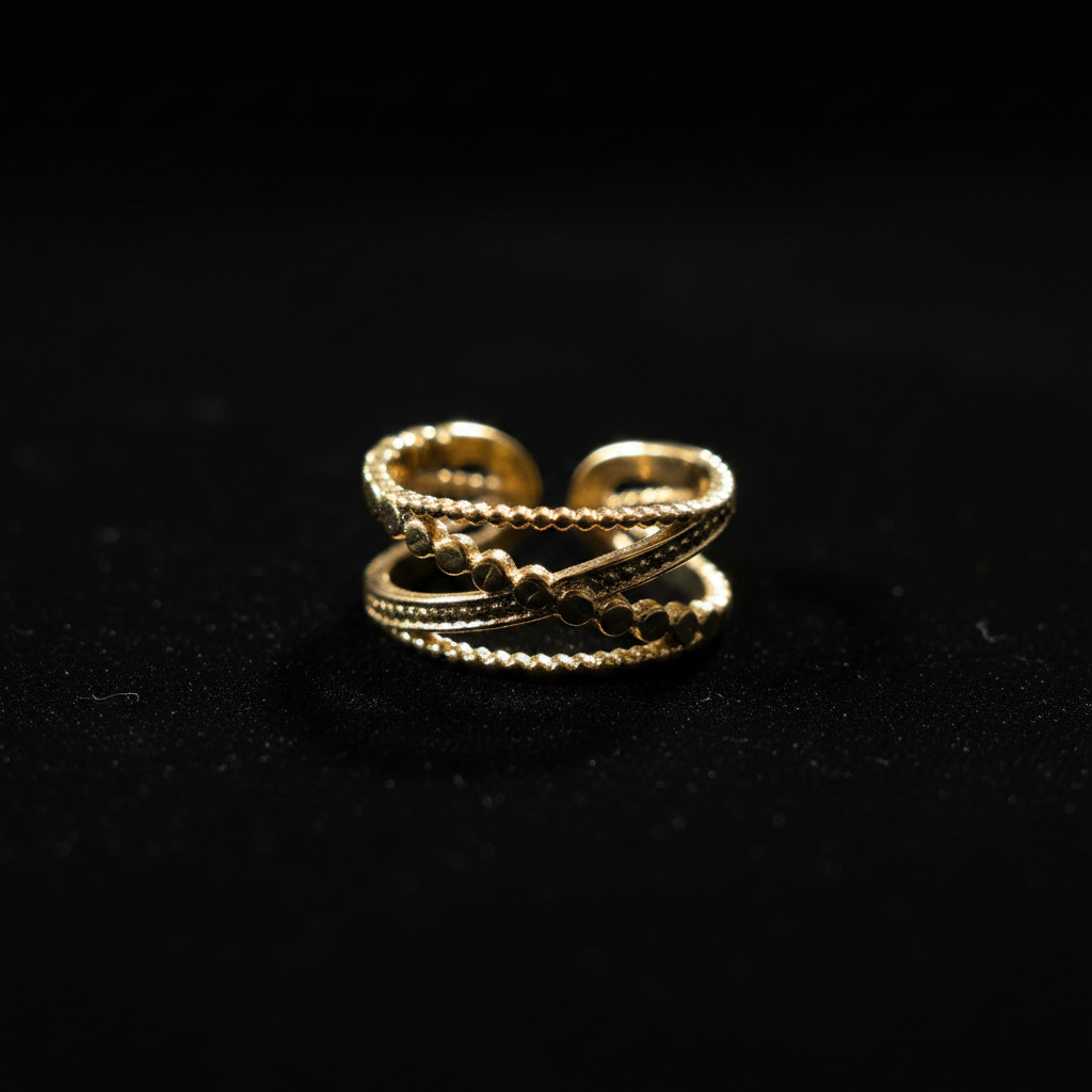 Gold double layer beaded heart open cuff ring on black velvet with dramatic rim lighting