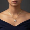 Model wearing CZ sunburst cluster pendant necklace on gold herringbone snake chain - sparkling round and pear CZ stones with gold swirl design