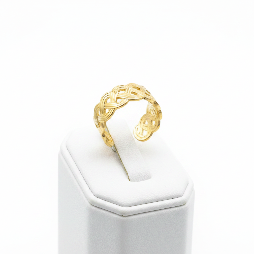 Gold infinity knot weave open cuff ring on white jewelry stand, clean studio shot