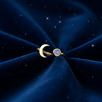 Gold moon and moonstone ring on midnight blue velvet fabric