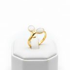 Gold double oval stone bypass open cuff ring on white jewelry stand, clean studio shot