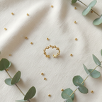 Gold beaded bubble band open cuff ring on ivory linen with gold beads and eucalyptus