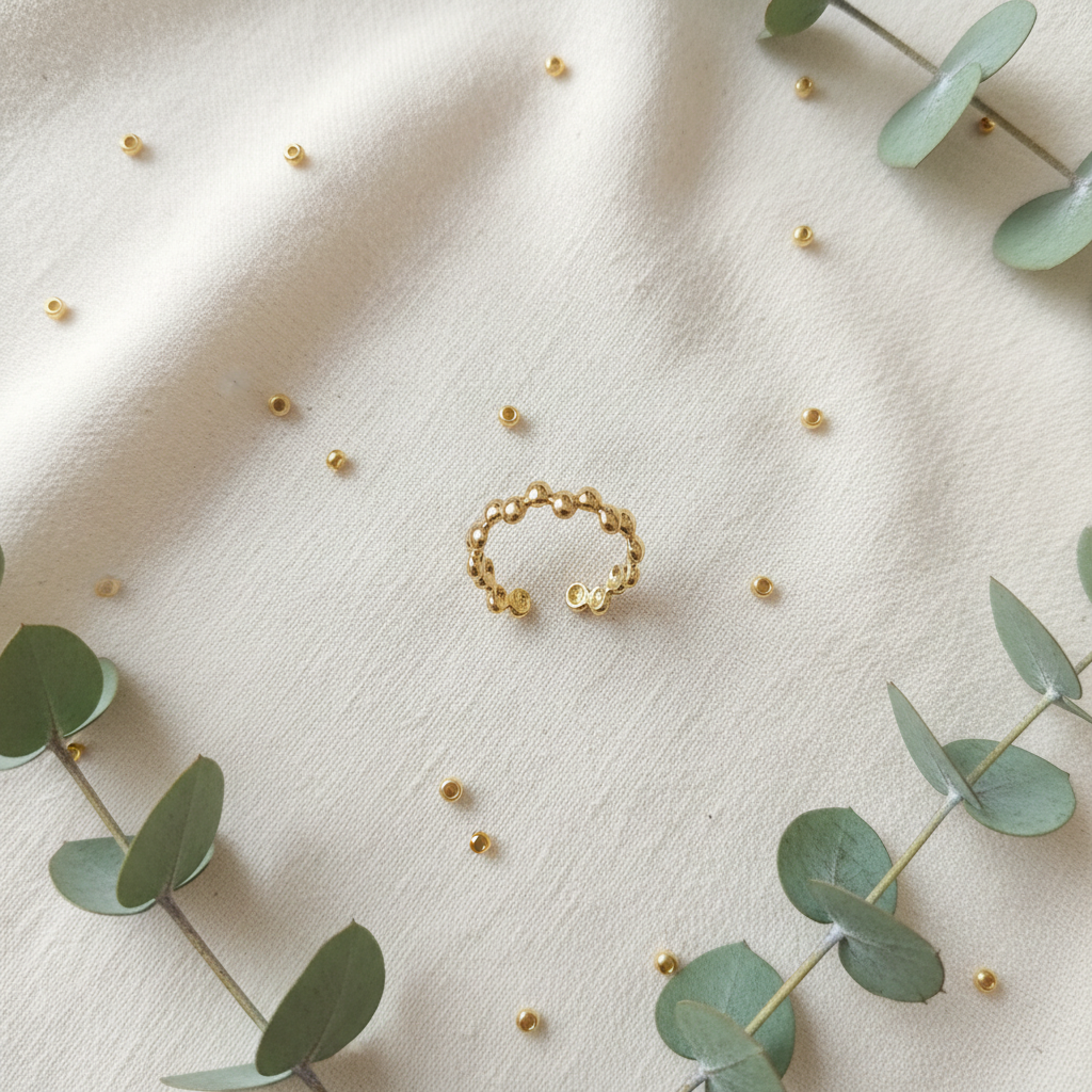 Gold beaded bubble band open cuff ring on ivory linen with gold beads and eucalyptus