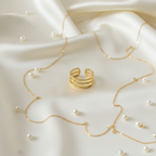 Gold triple layer open cuff ring on ivory silk with pearls and gold chain