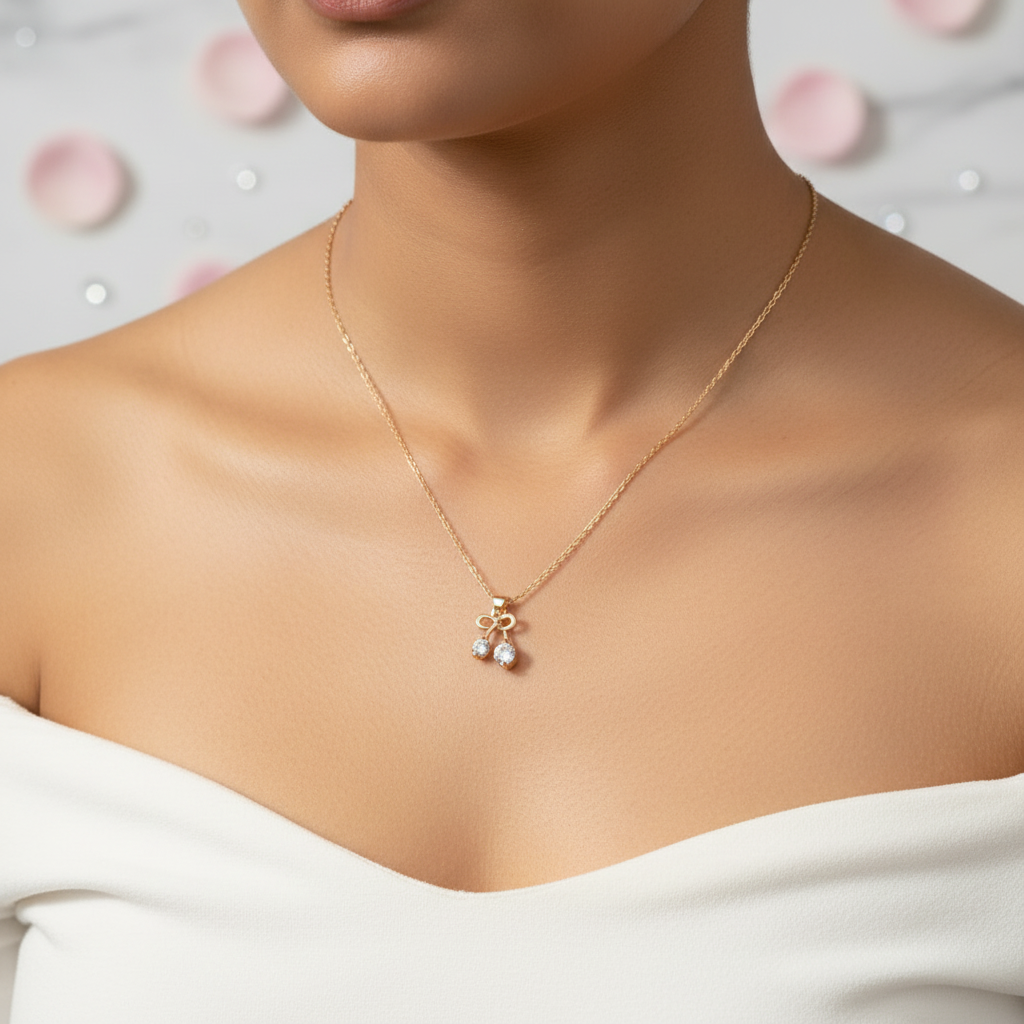 Model wearing gold bow pendant necklace with two CZ crystal drops on gold cable chain - feminine editorial jewelry by Violet Vows