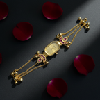 Peacock Charm Bracelet Watch Ruby Edition – dark moody flat lay