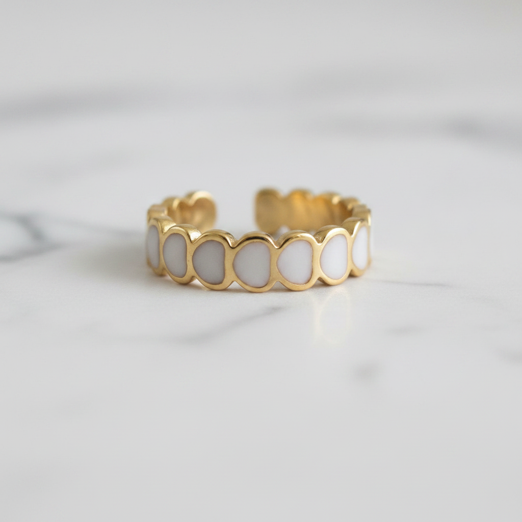 Gold white oval enamel wide band open cuff ring on white marble surface