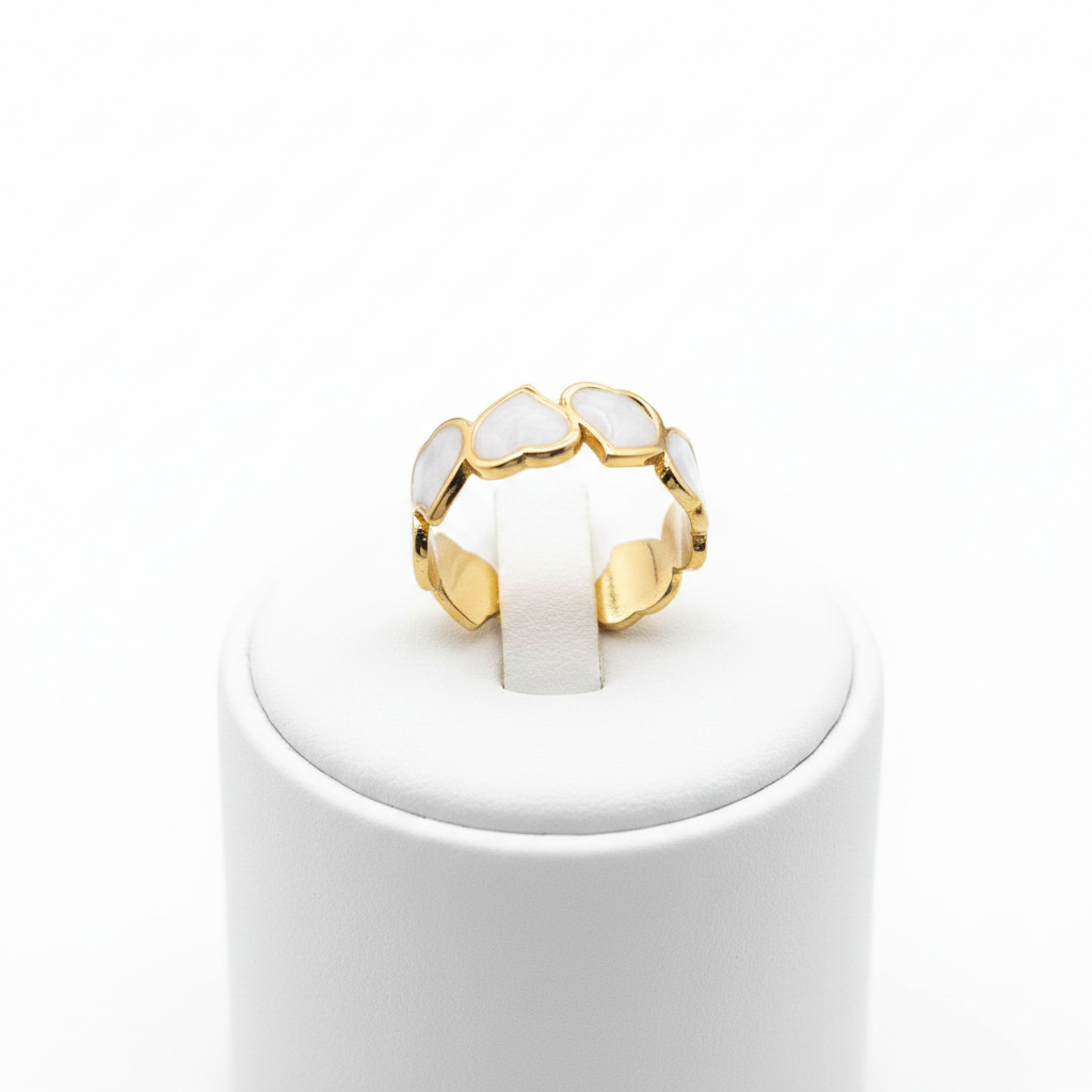 Gold white enamel heart band open cuff ring on white jewelry stand, clean studio shot