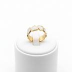 Gold white enamel heart band open cuff ring on white jewelry stand, clean studio shot