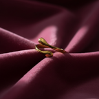 Gold hug ring on rose pink velvet fabric