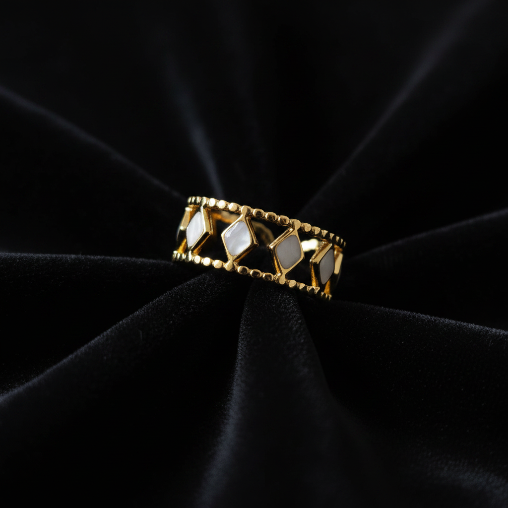 Gold diamond cutout lace crown ring on black velvet fabric