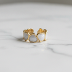 Gold white enamel heart band open cuff ring on white marble surface
