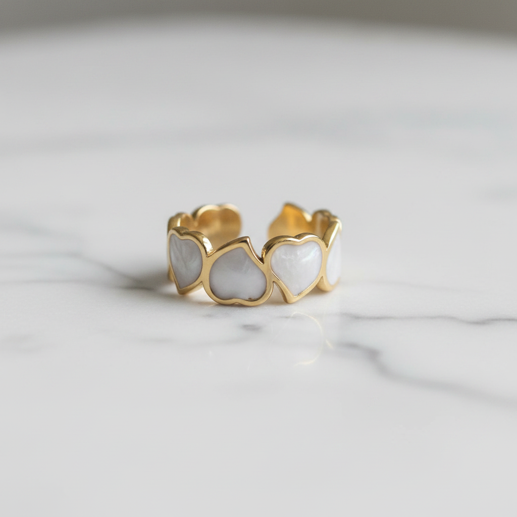 Gold white enamel heart band open cuff ring on white marble surface