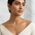 Model wearing gold spiral stud earrings and matching spiral pendant necklace on gold chain - editorial jewelry set by Violet Vows