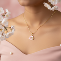 Model wearing pink triangular enamel pendant necklace with white pearl and CZ leaf accent on gold oval link chain - feminine jewelry by Violet Vows